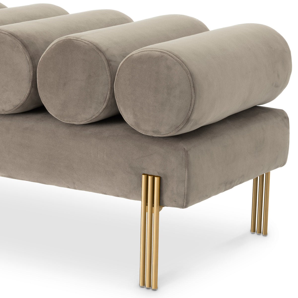 Close-up of Oxley velvet roll cushions and brushed brass legs