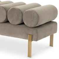 Close-up of Oxley velvet roll cushions and brushed brass legs